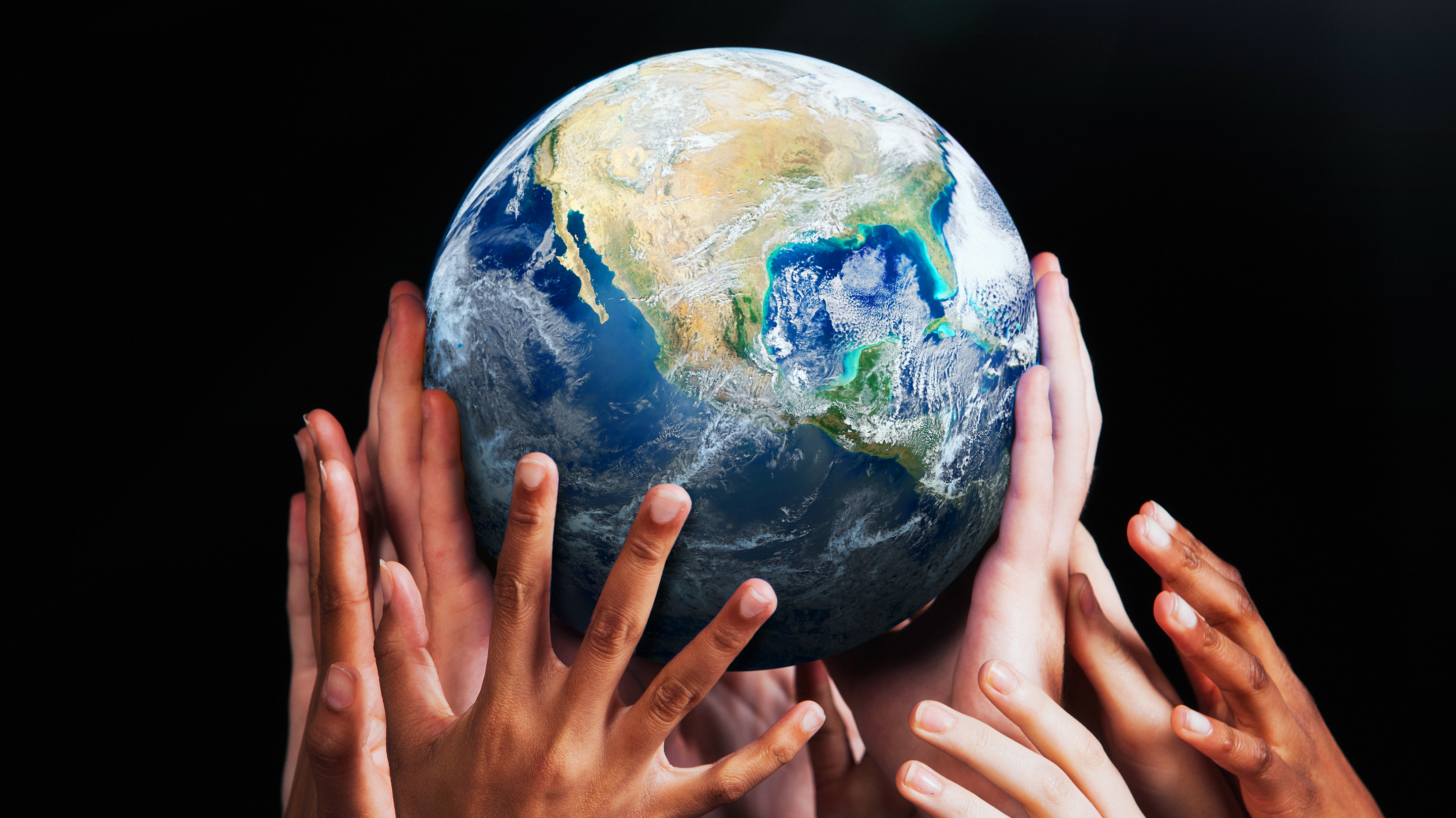 Hands holding up an earthglobe